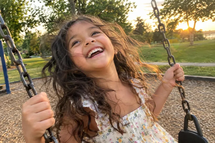 Maya on a swing at sunset